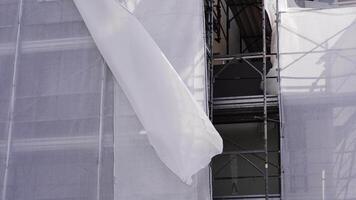 Downtown building scaffolding with torn off fabric sheet video