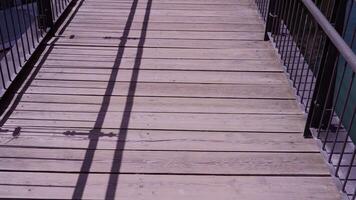 old boards on retro bridge with railing over narrow channel video
