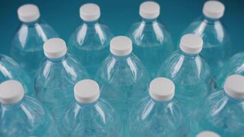 lines of bottles with water and caps shaking on light blue video