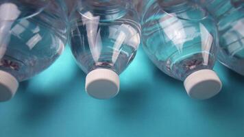 row of closed bottles with refreshing drink on light blue video