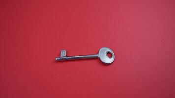 vintage drawer key with round head falls down on red surface video