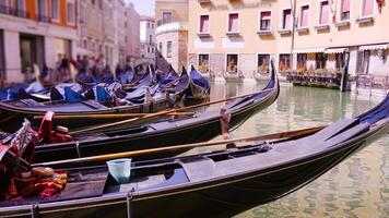 gondolas with comfortable chairs on channel in Venice video