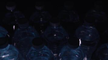 ray of light moves over plastic bottles with clean water video