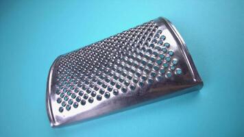 grater for cheese and citruses on light blue background video