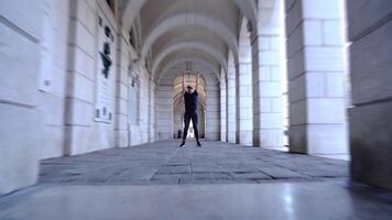Active man performs modern ballet dance in historic building video