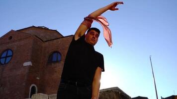 Dancer performs on square with ancient buildings in summer video