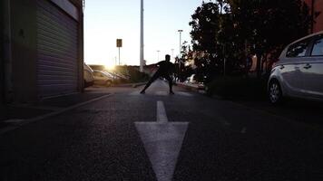 Dancer silhouette performs on zebra crossing at sunset video
