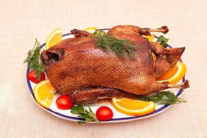 Homemade baked duck. Crispy whole roast duck. Thanksgiving or Christmas dinner. photo