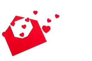 Red envelope with a white sheet of paper and red hearts on a white background. Valentine's day greeting card. photo