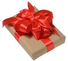 Box is wrapped in brown paper and red ribbon on a white isolated background photo