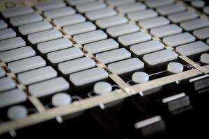 Electronic configurable keypad controller for audio and light shows production with white symmetric buttons in a grid photo