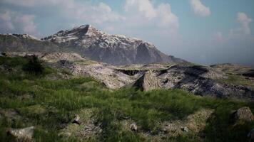 A panoramic view of rocky terrain and lush grass under a clear sky video