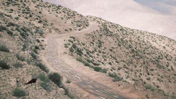 Winding path through the Pamir mountains in Tajikistan on a sunny day video