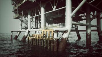 Old oil platform structure above calm waters during a cloudy day video