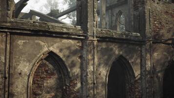 Abandoned stone structure with intricate arches surrounded by overgrown trees video