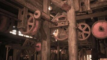 Detailed view of vintage gears and wooden structures in an old workshop video