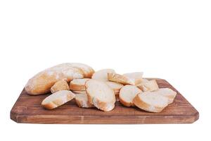 Fresh sliced baguette on wooden board isolate on white background. Bread photo