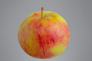 Red apple with yellow isolated on gray background. photo