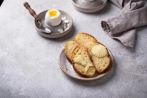 Breakfast with boiled eggs, bread and butter photo