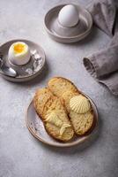 Breakfast with boiled eggs, bread and butter photo