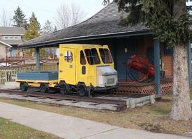 A small yellow train on a track photo