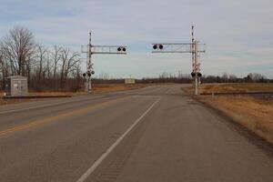 A road with a train crossing photo