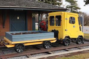 A yellow train car with a small garden on it photo