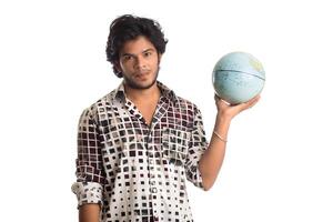young man with a world globe on a white background. photo