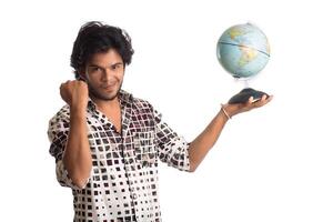 young man with a world globe on a white background. photo