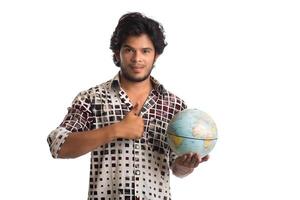 young man with a world globe on a white background. photo