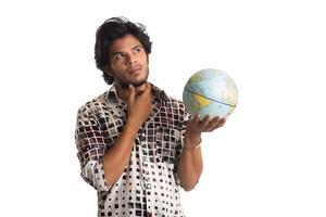 young man with a world globe on a white background. photo