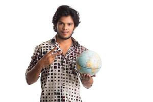 young man with a world globe on a white background. photo