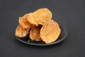 Delicious khaja of puri in black plate and background photo