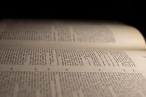 macro photography of a book page with text in Latin font photo