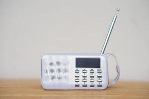 Mini portable radio. Concept, audio electronics for listening to music, songs or news from radio wave channel station. Analog amplifier technology for relaxation and lifestyle. photo