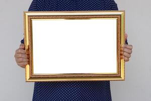 Closeup woman holds empty photo frame or blank diploma certificate frame. Copy space for adding text or photos. Concept, Proud, memories and nostalgia .