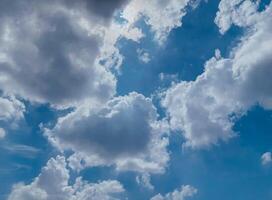 Sky background image. Bottom up view of beautiful blue sky and white clouds at noon in summer. photo