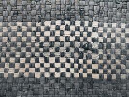 The background texture and pattern of the floor mat are made from white and dark blue patchwork photo
