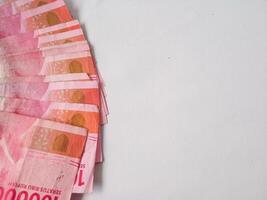 Indonesian money in the hundred thousand rupiah denomination isolated on white background photo