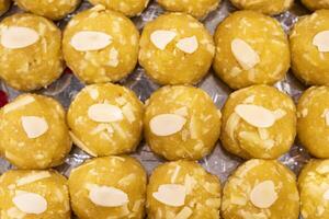 Mawa Laddu topping with nuts texture closeup top view of indian, pakistani and bangladeshi sweets dessert photo