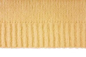 Yellow knitted woolen jersey fabric, sweater texture with edge isolated on white background photo