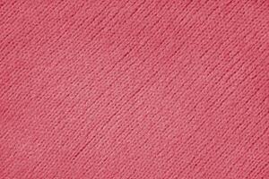 Red knitted woolen jersey fabric with diagonal weaving, sweater, pullover texture background photo