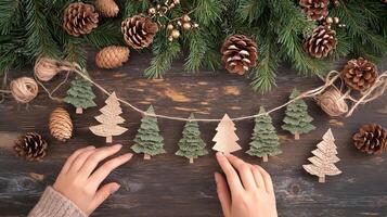 Holiday decoration with paper trees and pine cones on wooden background. Decor and craftwork, eco friendly, sustainable concept. photo