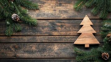 Wooden Christmas tree with pine branches and cones on rustic wooden background. Christmas handmade decor and craftwork, eco friendly, sustainable concept. Place for text. photo