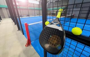 padel racket on a padel court with a ball photo