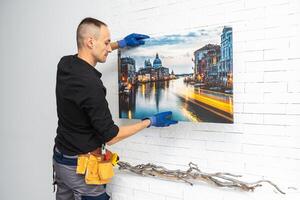 Photo canvas print. A man holding a photography with gallery wrap