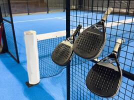 padel racket on a padel blue court with a ball photo