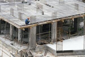 Construction workers working on Construction machine. Aerial platform for workers who work at height on buildings. photo