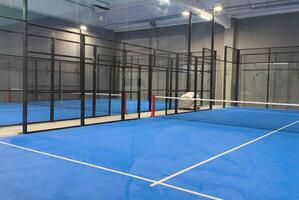 Padel court with lines and net indoor photo