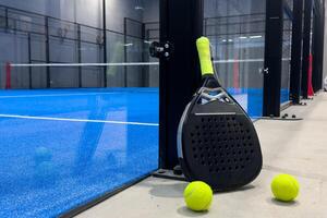 padel racket on a padel court with a ball photo